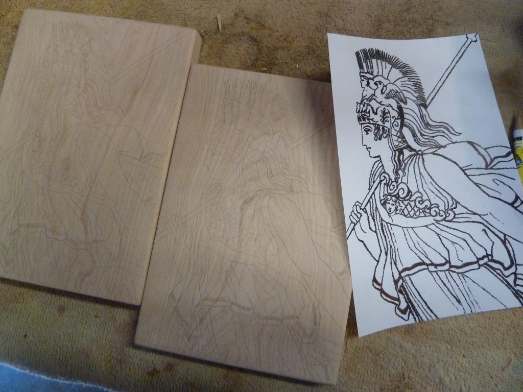 The image of Athena on paper, and the same image sketched onto both pieces of wood.